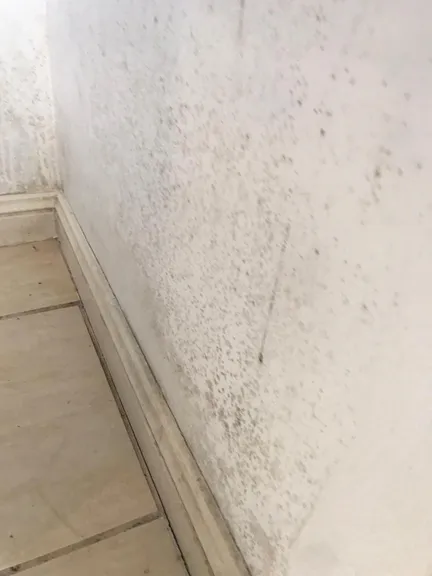 Bedroom before cleaning - sandy and cluttered surfaces